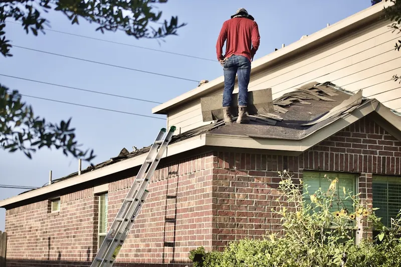 Professional roofer working on a residential roof in Matovich